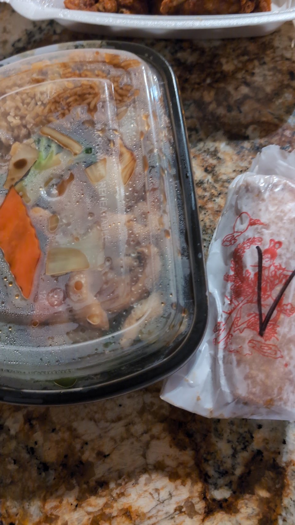 Takeout menu beside a restaurant meal